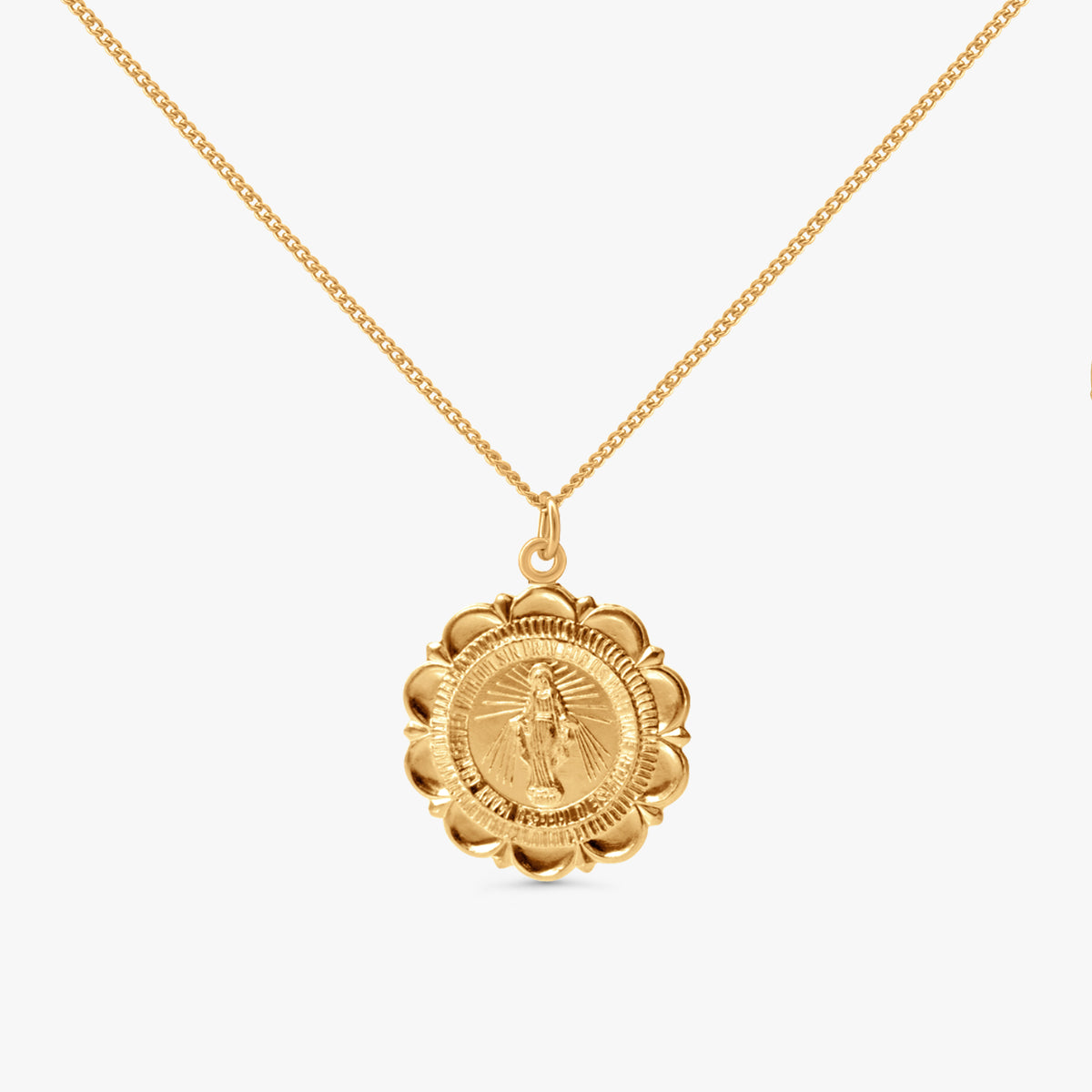 A gold chain necklace with a circular medallion pendant featuring a detailed religious figure, shown against a plain light gray background.