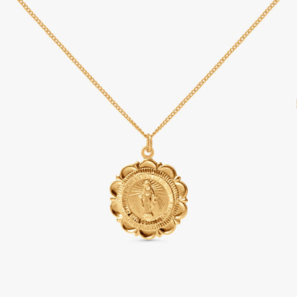 A gold chain necklace with a circular medallion pendant featuring a detailed religious figure, shown against a plain light gray background.