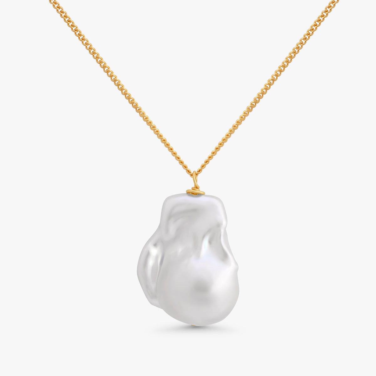 A gold chain necklace featuring a large, irregular white baroque pearl pendant, shown against a clean light gray background.