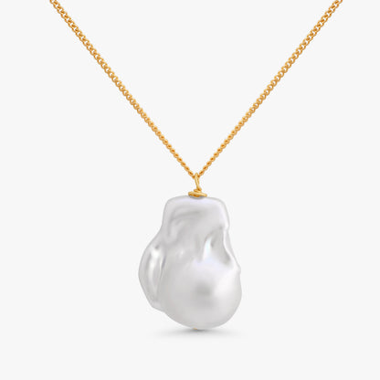 A gold chain necklace featuring a large, irregular white baroque pearl pendant, shown against a clean light gray background.