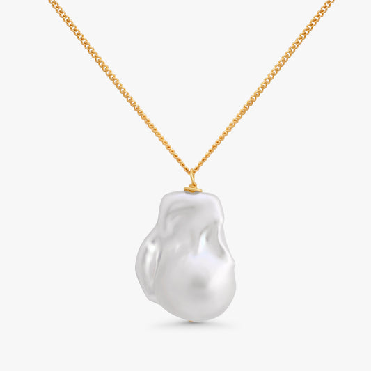 A gold chain necklace featuring a large, irregular white baroque pearl pendant, shown against a clean light gray background.