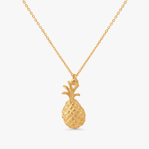 A gold pineapple pendant necklace on a delicate gold chain, presented against a clean, light gray background.