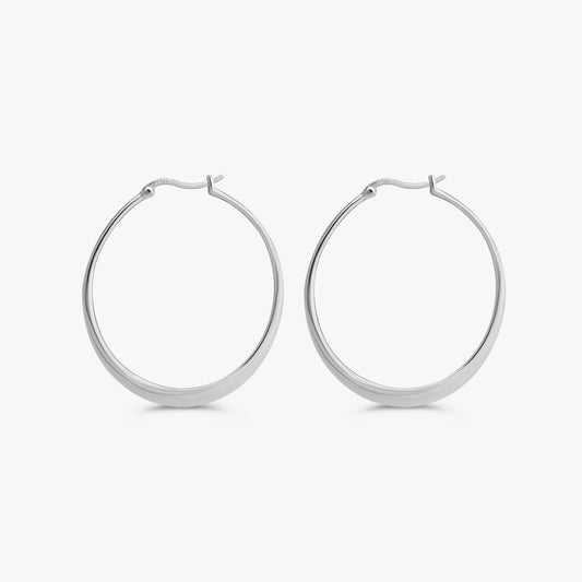 A pair of polished silver hoop earrings with a flat, wide band and secure clasp backings, shown against a clean, light gray background.