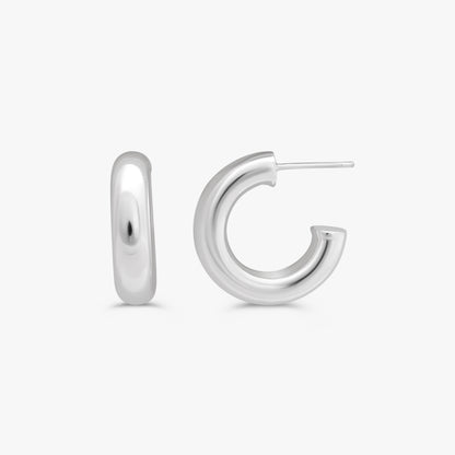 A pair of polished sterling silver hoop earrings, one shown from a front-facing perspective and the other from a side profile showing the post, on a light gray background.