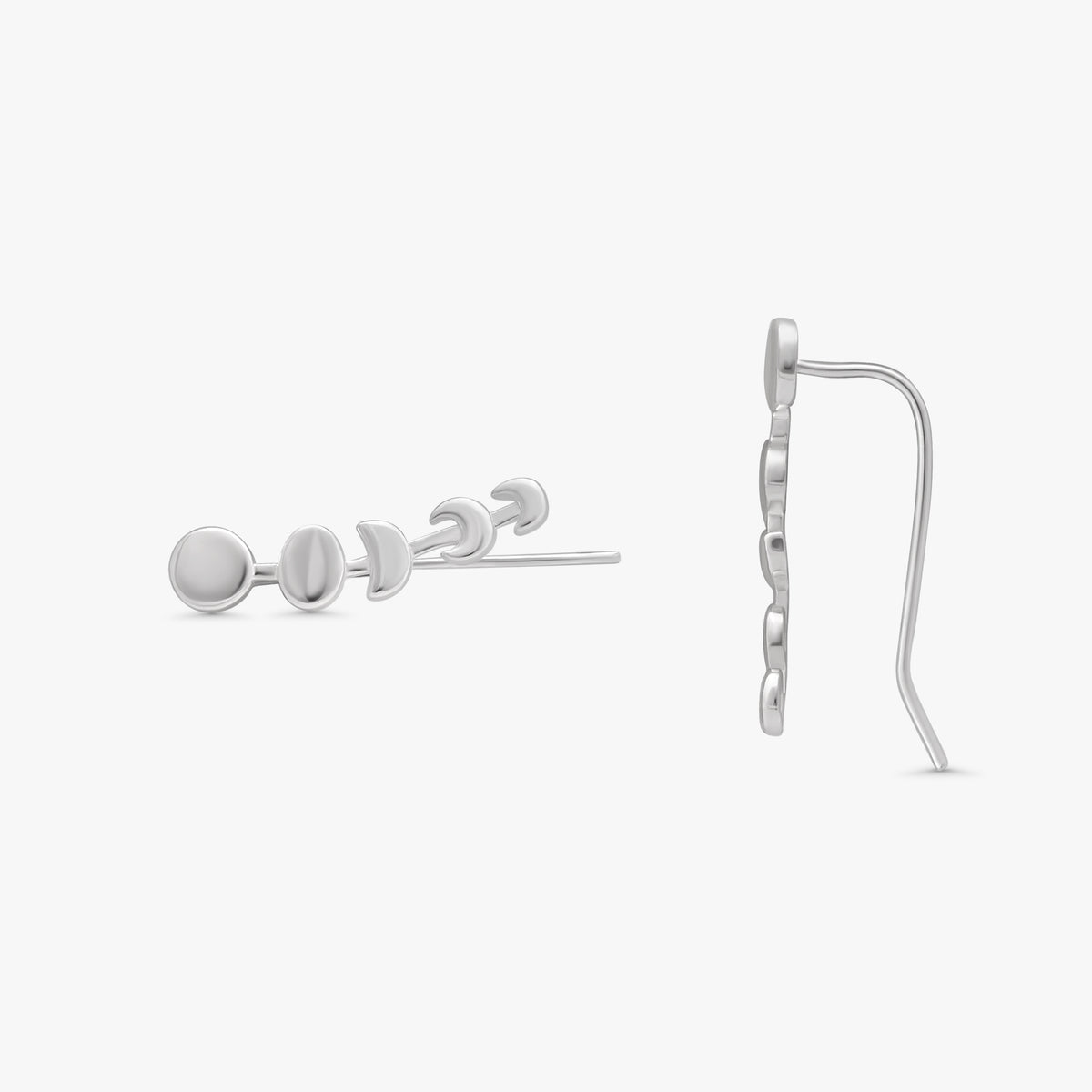 A pair of silver stud earrings shown on a light gray background, with one earring viewed from the side and the other from the front, displaying a circular disc design.