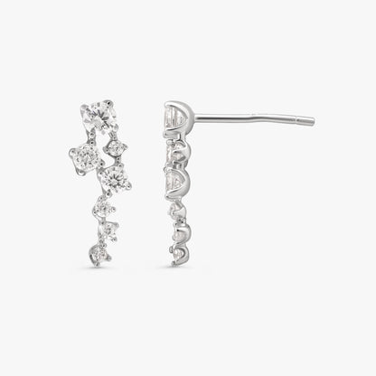 A pair of silver dangle earrings with clear gemstones, shown from both front and side angles against a light gray background.