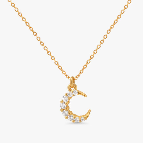 A gold chain necklace with a crescent moon pendant adorned with small clear stones, shown against a light gray background.