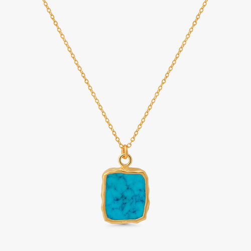 A gold chain necklace with a square pendant featuring a vibrant turquoise blue stone with natural white veining, set in a rustic gold bezel, on a light gray background.