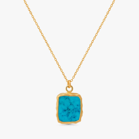 A gold chain necklace with a square pendant featuring a vibrant turquoise blue stone with natural white veining, set in a rustic gold bezel, on a light gray background.