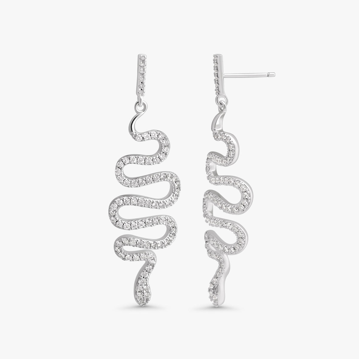 A pair of silver drop earrings with a wavy, snake-like spiral design set with small clear stones, shown against a plain light gray background.