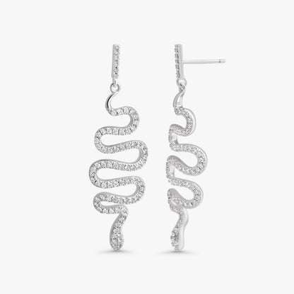 A pair of silver drop earrings with a wavy, snake-like spiral design set with small clear stones, shown against a plain light gray background.