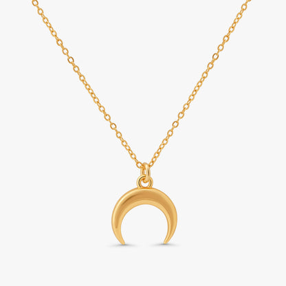A gold crescent moon pendant necklace on a delicate gold chain, shown against a light gray background.