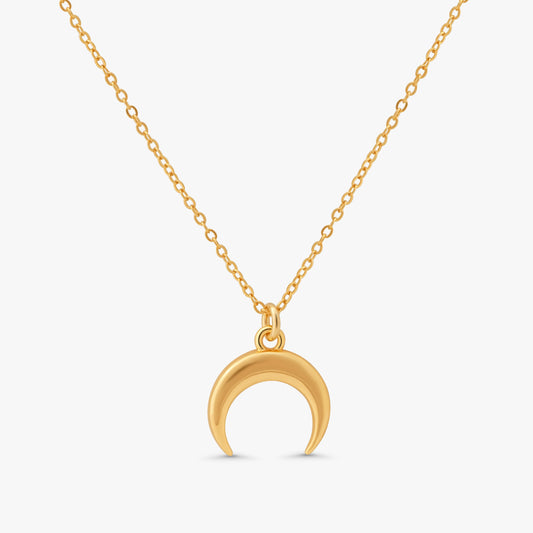 A gold crescent moon pendant necklace on a delicate gold chain, shown against a light gray background.