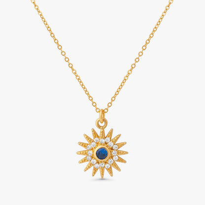 Sunniva Sun Ray & Starburst 14k gold filled necklace with blue sapphire and crystal sunburst pendant on white background