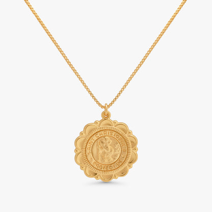 A gold pendant necklace featuring a detailed, circular, medallion-style charm with a raised figure in the center and the words 'CHRISTIANOF' and 'PRINCE' engraved around the border, suspended from a delicate gold chain against a light gray background.
