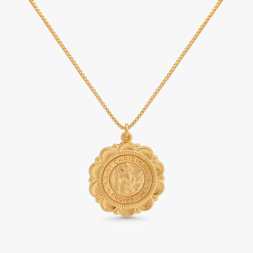 A gold pendant necklace featuring a detailed, circular, medallion-style charm with a raised figure in the center and the words 'CHRISTIANOF' and 'PRINCE' engraved around the border, suspended from a delicate gold chain against a light gray background.