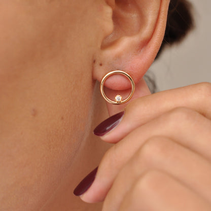 Woman wearing Ora Circle Solitaire 14k gold plated stud earring side view