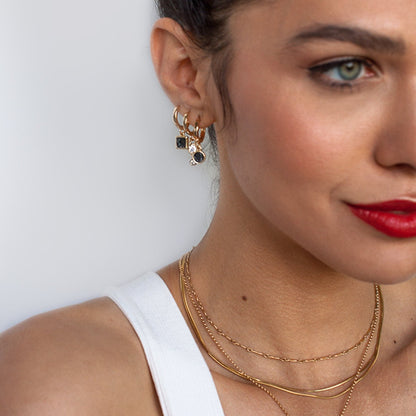 Angled portrait of woman with red lipstick wearing stacked Dagny Flat Bar 14k gold filled necklaces
