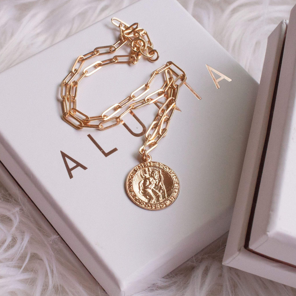 Auri Saint Christopher 14k gold filled coin necklace displayed on white Alunia gift box