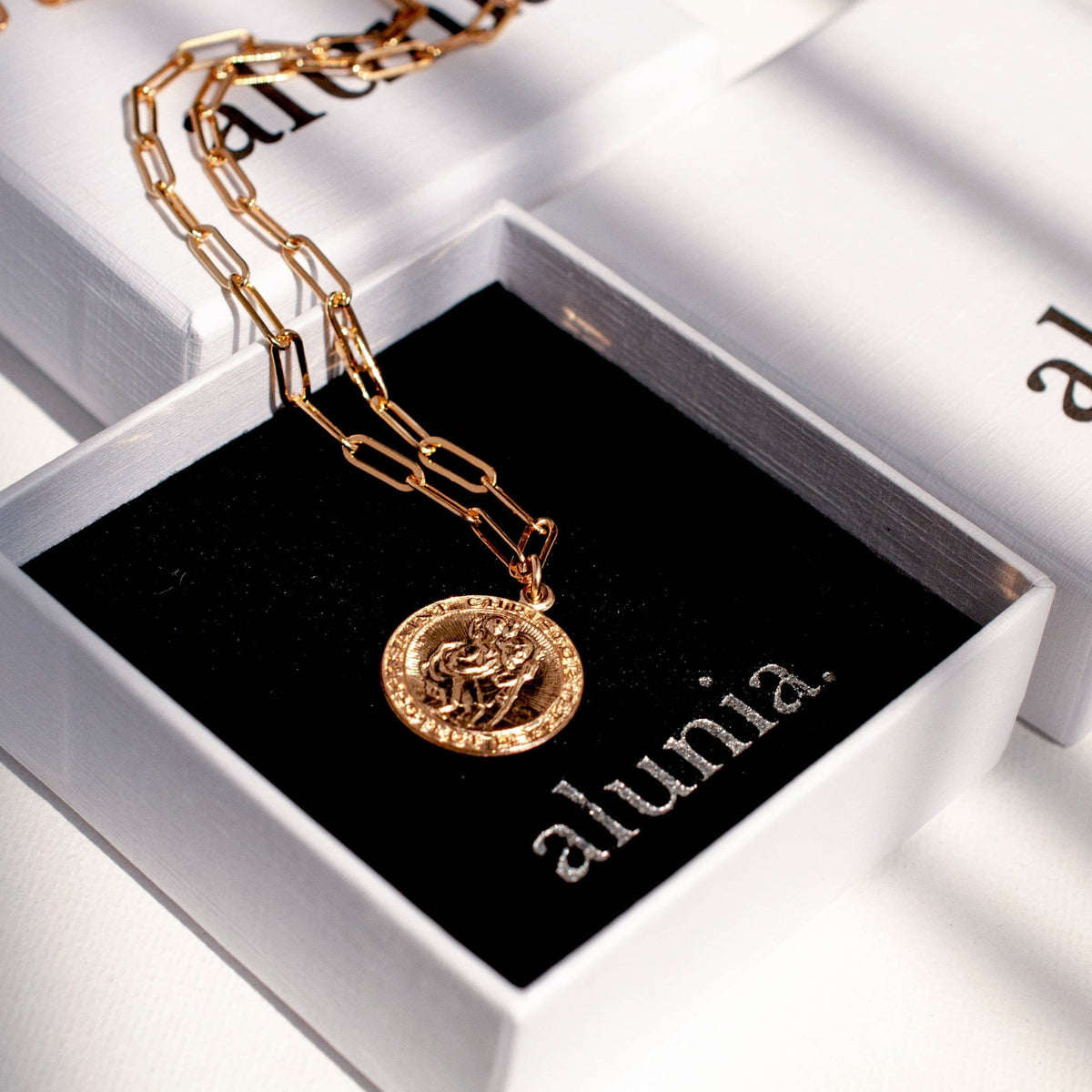 Auri Saint Christopher 14k gold filled paperclip necklace presented inside black Alunia jewelry box