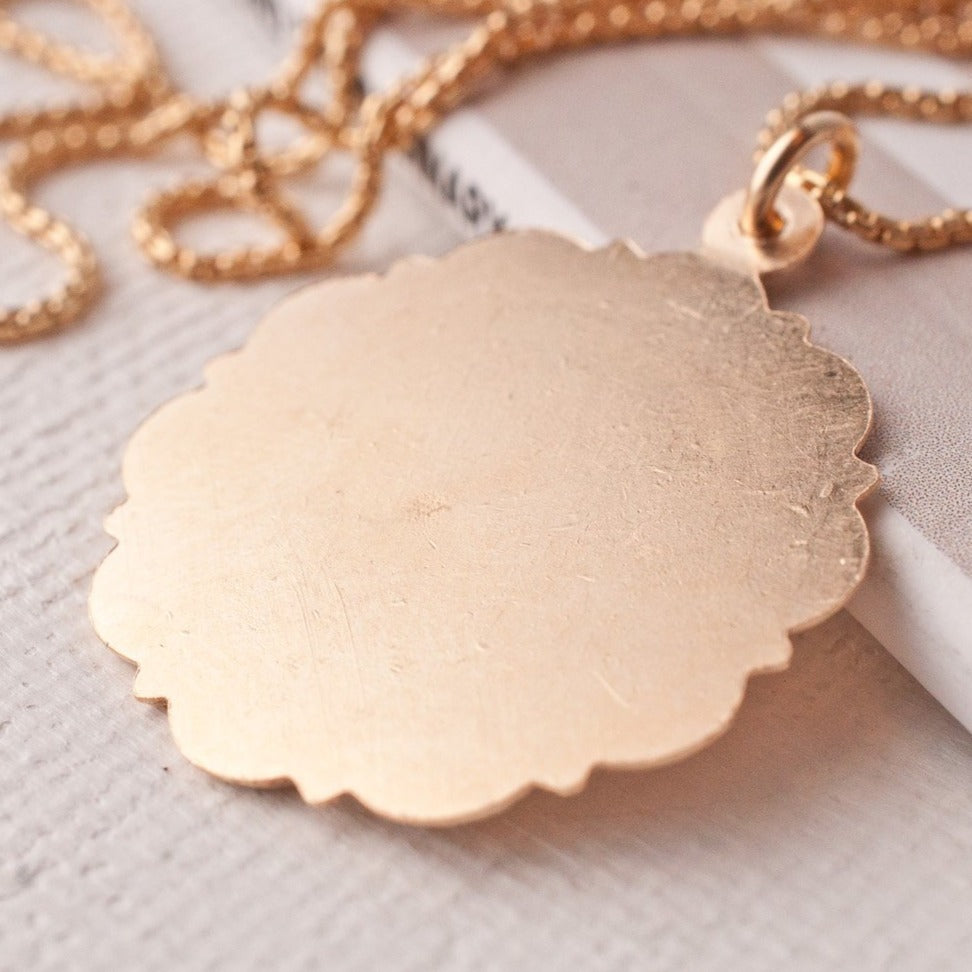 Back view of Viva Saint Christopher 14k gold filled scalloped medallion showing smooth gold surface