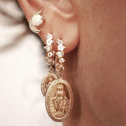 Close-up of a woman's ear wearing a 14k Gold Plated Tuva Opal Moon Stud paired with a medallion hoop.