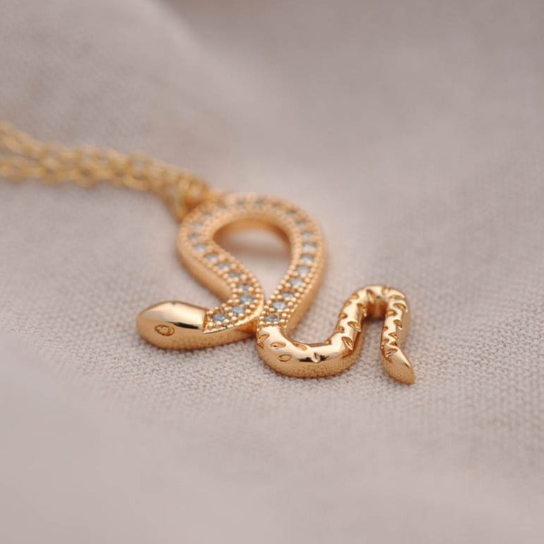 Close-up view of Jolie Snake 14k gold filled pendant necklace with textured serpent charm