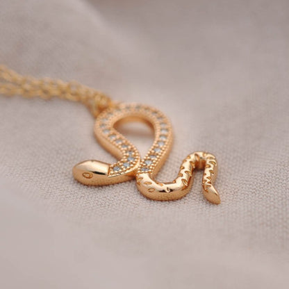 Close-up view of Jolie Snake 14k gold filled pendant necklace with textured serpent charm