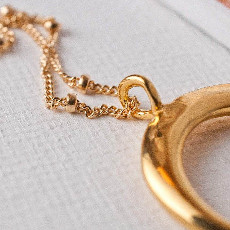 Detail shot of Ro Horn 14k gold filled satellite chain loop attachment to gold horn pendant