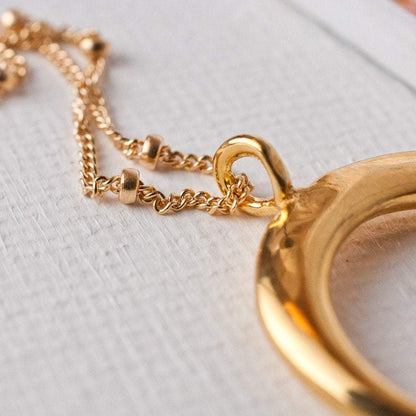 Detail shot of Ro Horn 14k gold filled satellite chain loop attachment to gold horn pendant