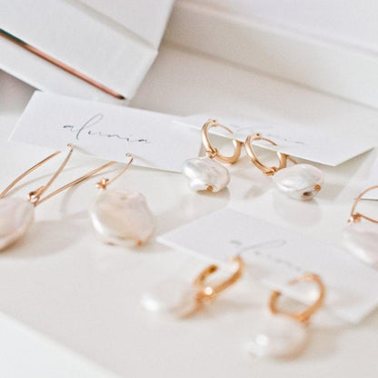 Multiple Sienna Keshi Pearl gold hoop earrings displayed together