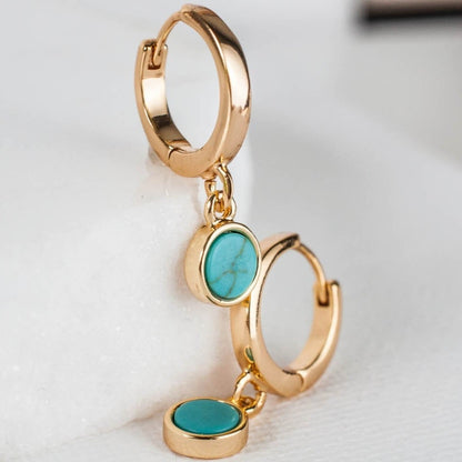 Pair of women's 14k Gold Plated Riva Turquoise Charm Hoop Earrings stacked vertically on a white surface.