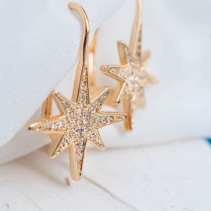 Pair of women's 14k Gold Plated Sola Starburst Earrings displayed flat on a white surface with gentle shadows.
