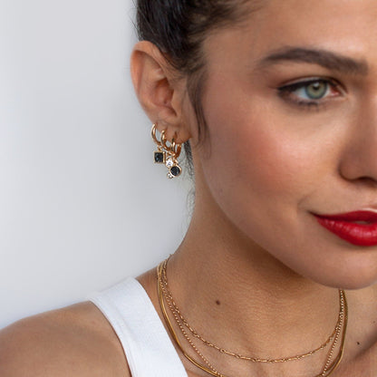 Portrait of a woman with red lipstick wearing 14k Gold Plated Ziva Druzy Hoop Earrings and layered gold chains.