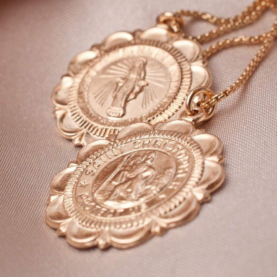 Two Viva Saint Christopher 14k gold filled scalloped coin medallions stacked together on neutral background