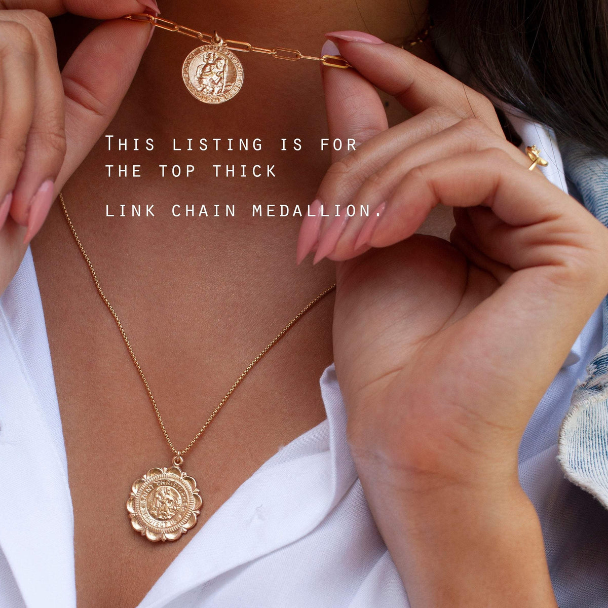 Woman wearing Auri Saint Christopher 14k gold filled paperclip necklace holding coin medallion pendant