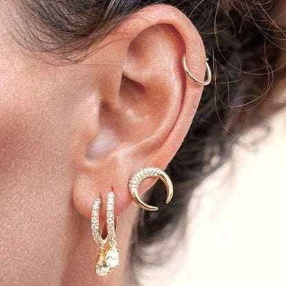 Woman wearing Bravi Double Horn 14k gold plated stud earring side profile view