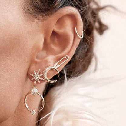 Woman wearing Bravi Double Horn Stud in 14k gold plated metal as part of an ear stack