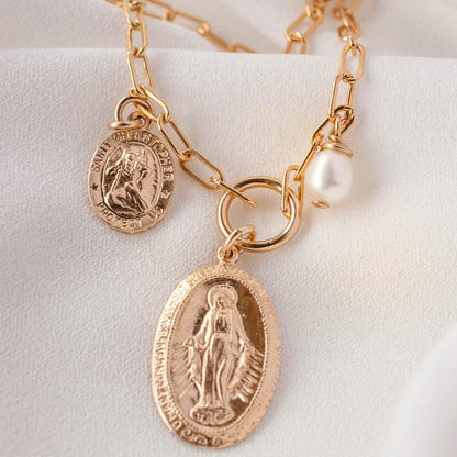 Zoya Mary Saint Christopher 14k gold filled paperclip charm necklace displayed on light cream background